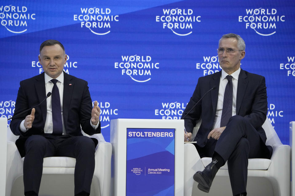 Andrzej Duda, left, President of Poland and Secretary General of NATO Jens Stoltenberg, right, attend a panel at the World Economic Forum in Davos, Switzerland Wednesday, Jan. 18, 2023. The annual meeting of the World Economic Forum is taking place in Davos from Jan. 16 until Jan. 20, 2023. (AP Photo/Markus Schreiber)