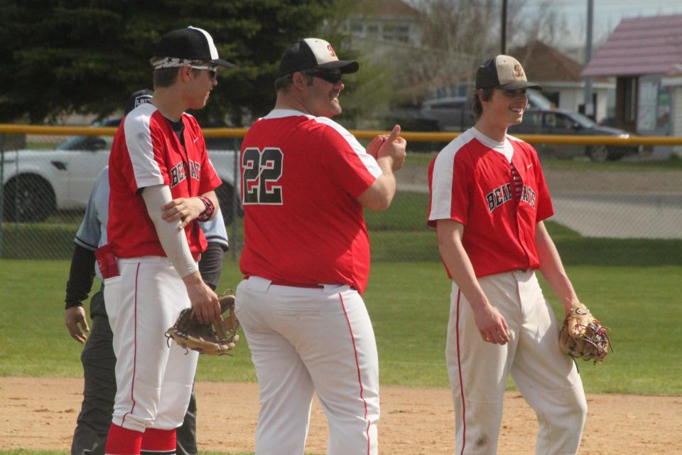 North Star Baseball head coach Jesse Vote (middle) visits the mound to switch pitchers against Rugby on May 24.