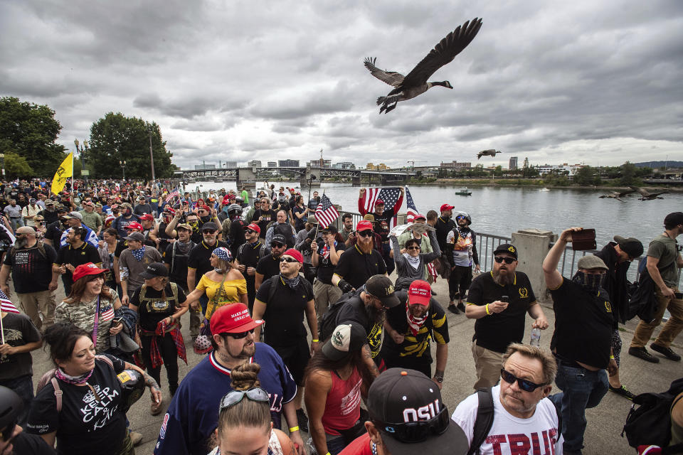 Members of the Proud Boys and other right-wing demonstrators march along the Willamette River during an &quot;End Domestic Terrorism&quot; rally in Portland, Ore., on Saturday, Aug. 17, 2019. Police have mobilized to prevent clashes between conservative groups and counter-protesters who converged on the city. (AP Photo/Noah Berger)