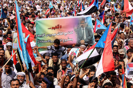 Supporters of the separatist Southern Movement demonstrate against recent decisions by President Abd-Rabbu Mansour Hadi that sacked senior officials supported by the United Arab Emirates, including governor of the southern Yemeni port city of Aden, Aidaroos al-Zubaidi (pictured in the banner) in Aden, Yemen May 4, 2017. The banner reads: "No regions. We all are with the leader Aidaroos al-Zubaidi and the drive for independence". REUTERS/Fawaz Salman