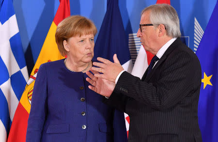 European Commission President Jean-Claude Juncker speaks with German Chancellor Angela Merkel during an informal EU summit on migration at EU headquarters in Brussels, June 24, 2018. Geert Vanden Wijngaert/Pool via Reuters