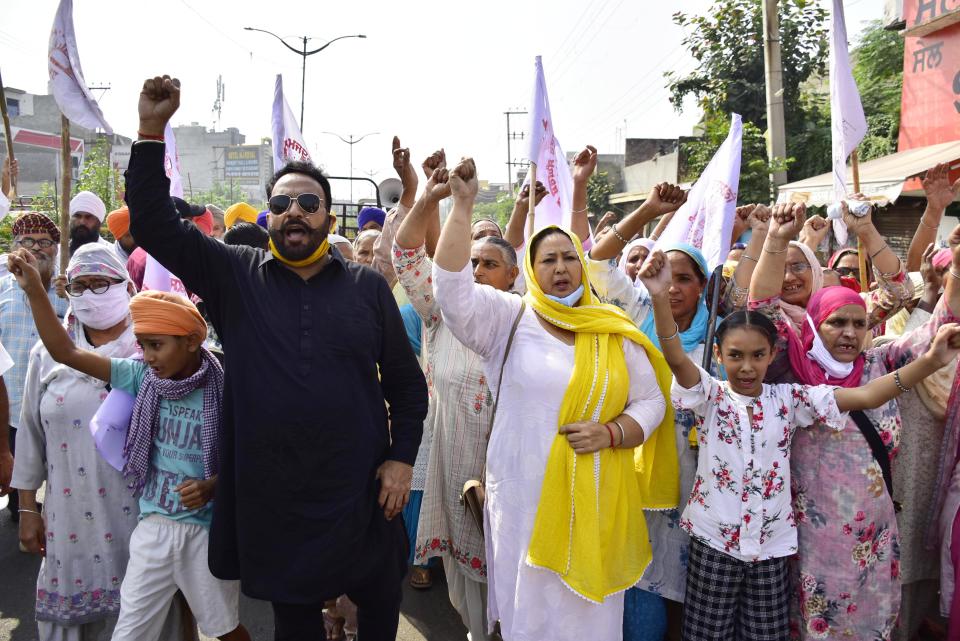 Punjabi actor Hardeep Gill and Punjabi actress Anita Devgun along with farmers and their family members shout slogans during Punjab bandh, a statewide farmers' strike against the recent passing of agriculture bills in the Parliament, on September 25, 2020 in Amritsar, India. The two bills - the Farmers (Empowerment and Protection) Agreement on Price Assurance and Farm Services Bill, 2020 and the Farming Produce Trade and Commerce (Promotion and Facilitation) Bill, 2020 - were passed by the Rajya Sabha despite uproar and strong protest by the Opposition parties in the house. (Photo by Sameer Sehgal/Hindustan Times via Getty Images)