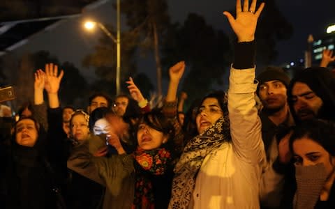 Iranians shout slogans against the government after a vigil held for the victims of the airplane of Ukrainian International Airlines  - Credit: Anadolu