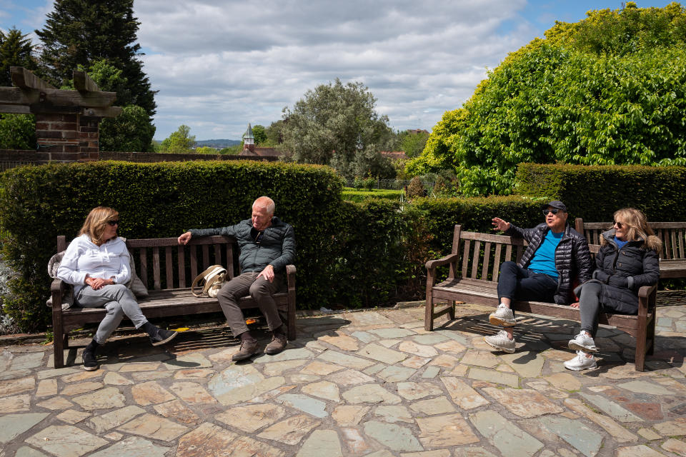 Two couples keep their distance as they enjoy the sunshine in Golders Hill Park.