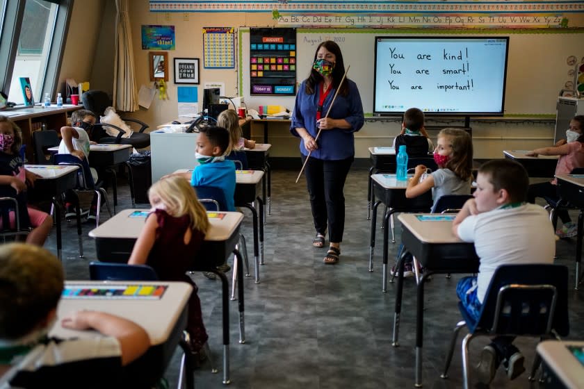 WEAVERVILLE, CA - AUGUST 17: Darsi Green speaks to students in her second grade glass at Weaverville Elementary School on the first day on returning to in-person instruction on Monday, Aug. 17, 2020 in Weaverville, CA. The Trinity Alps Unified School District reopened amid the coronavirus pandemic, resuming in-person classroom instruction. (Kent Nishimura / Los Angeles Times)