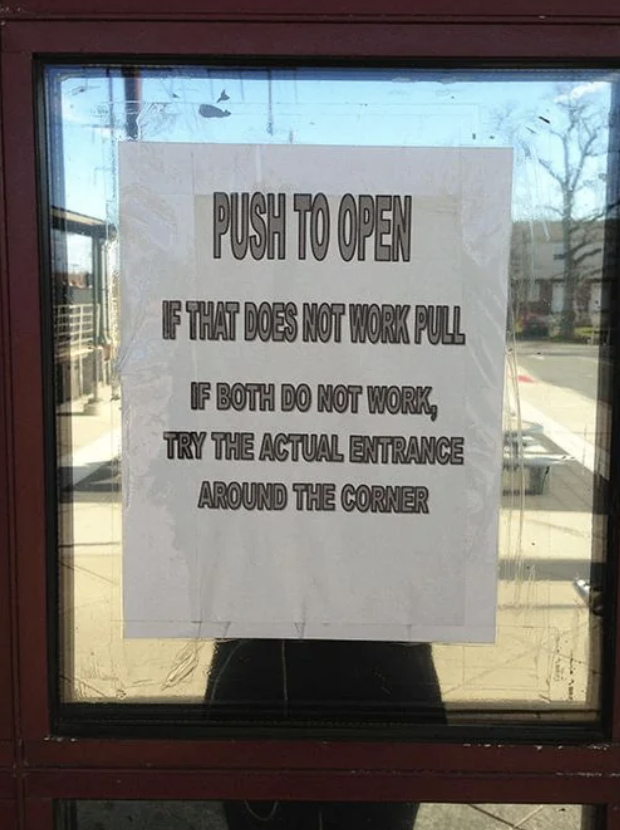 Sign on door reads "PUSH TO OPEN. If that does not work PULL. If both do not work, try the ACTUAL ENTRANCE around the corner."