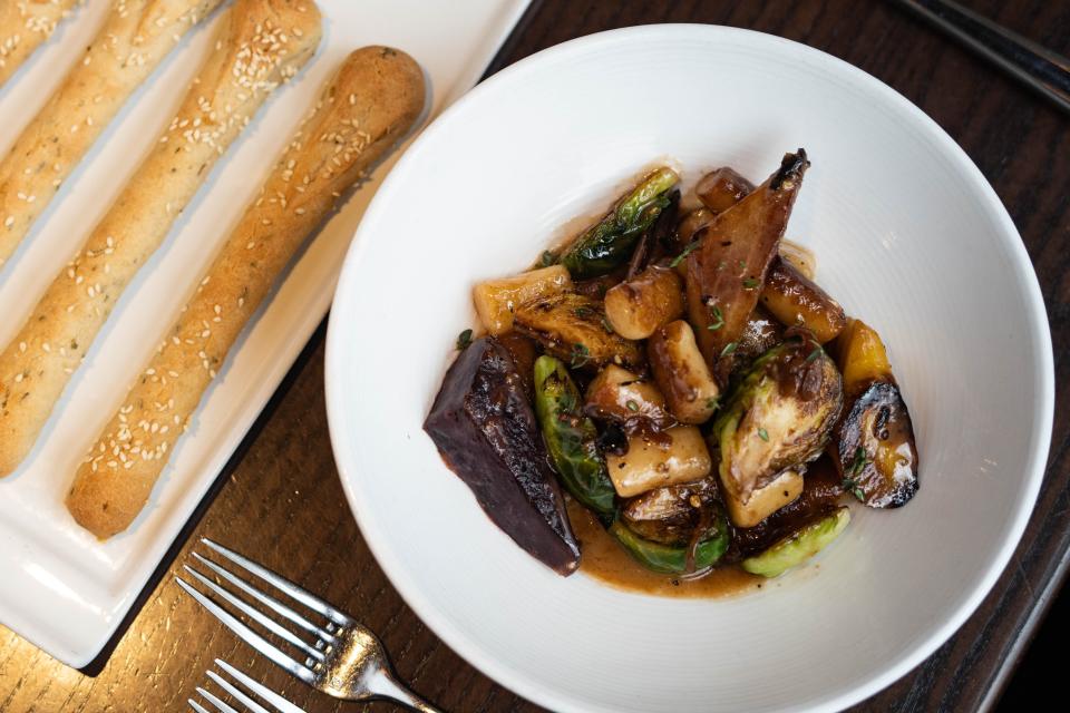 Posana's ricotta gnocchi with roasted rainbow carrots, brussels sprouts, cipollini onion, wine, butter, and thyme.