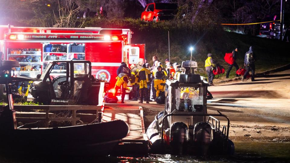 PHOTO: Rescue personnel gather on the shore of the Patapsco River after a cargo ship ran into the Francis Scott Key Bridge causing its collapse, in Baltimore, March 26, 2024.  (Jim Lo Scalzo/EPA via Shutterstock)