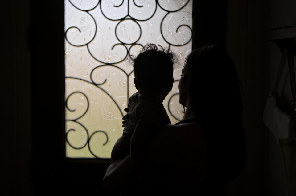 Ashley holds her baby at her home. (Danielle Villasana for The Washington Post)