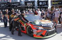 Crew members for Martin Truex Jr. move his car before practice for a NASCAR Cup Series auto race on Saturday, Nov. 16, 2019, at Homestead-Miami Speedway in Homestead, Fla. Truex one of four drivers racing for the championship. (AP Photo/Terry Renna)