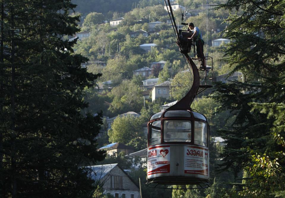 Kapanadze oils and checks a cable car during maintenance work in the town of Chiatura