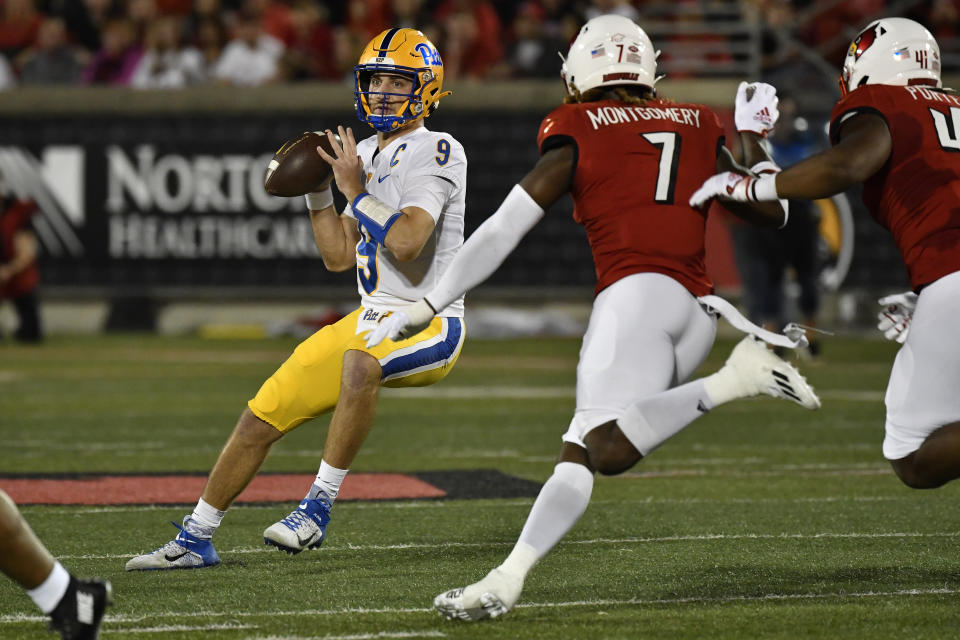 Pittsburgh quarterback Kedon Slovis (9) looks for an open receiver while pressured by Louisville linebacker Monty Montgomery (7) during the first half of an NCAA college football game in Louisville, Ky., Saturday, Oct. 22, 2022. (AP Photo/Timothy D. Easley)