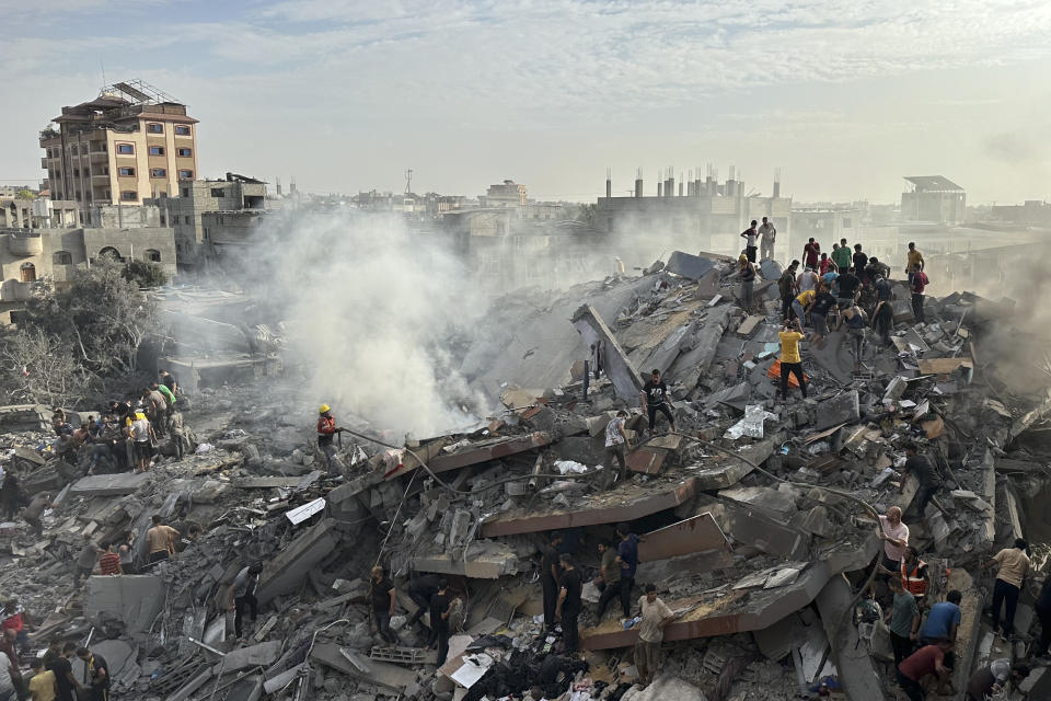 FILE - Palestinians look for survivors following Israeli airstrike in Nusseirat refugee camp, Gaza Strip, Oct. 31, 2023. Americans have become more likely to describe Israel as an ally that shares U.S. interests and values since the war with Hamas began, but they're divided over whether Israel has gone too far in its response to last month's attack, according to a new poll from The Associated Press-NORC Center for Public Affairs Research. (AP Photo/Doaa AlBaz, File)