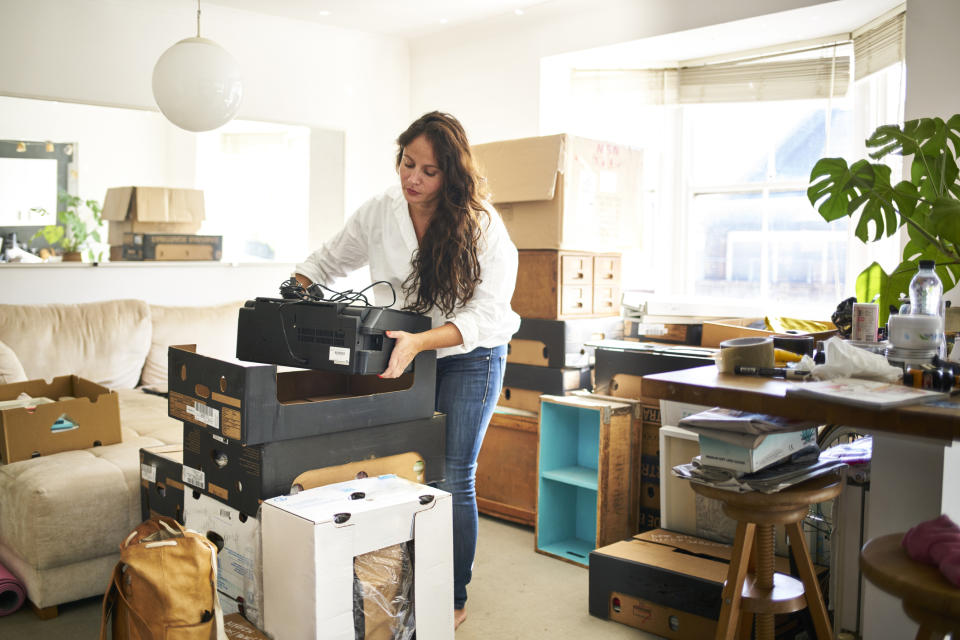 Woman decluttering her home. (Getty Images)