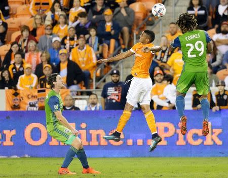 Nov 21, 2017; Houston, TX, USA; Houston Dynamo forward Erick Torres (9) and Seattle Sounders defender Roman Torres (29) fight for a header in the second half in the first leg of the MLS Western Conference Championship at BBVA Compass Stadium. Thomas B. Shea-USA TODAY Sports