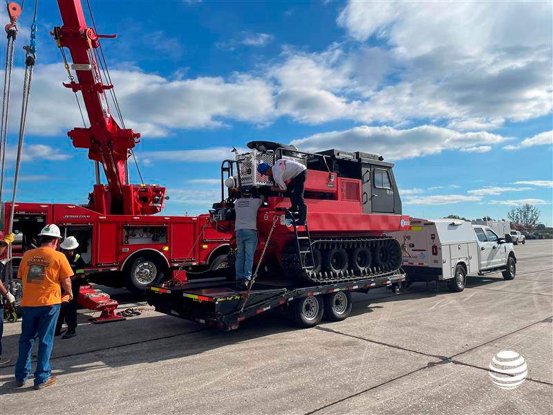 An amphibious vehicle provided by AT & T is off-loaded from a flatbed truck. It will be used to help with rescue efforts on Sanibel Island.