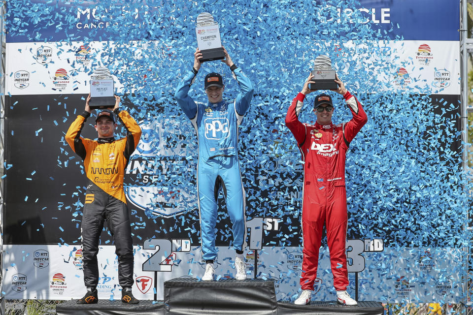 Team Penske driver Josef Newgarden, of the United States, center, celebrates his first place finish along with second place finisher Arrow McLaren driver Pato O'Ward of Mexico, left, and third place finisher Team Penske driver Scott McLaughlin of New Zealand in the IndyCar Grand Prix of St. Petersburg auto race, Sunday, March 10, 2024, in St. Petersburg, Fla. (AP Photo/Mike Carlson)