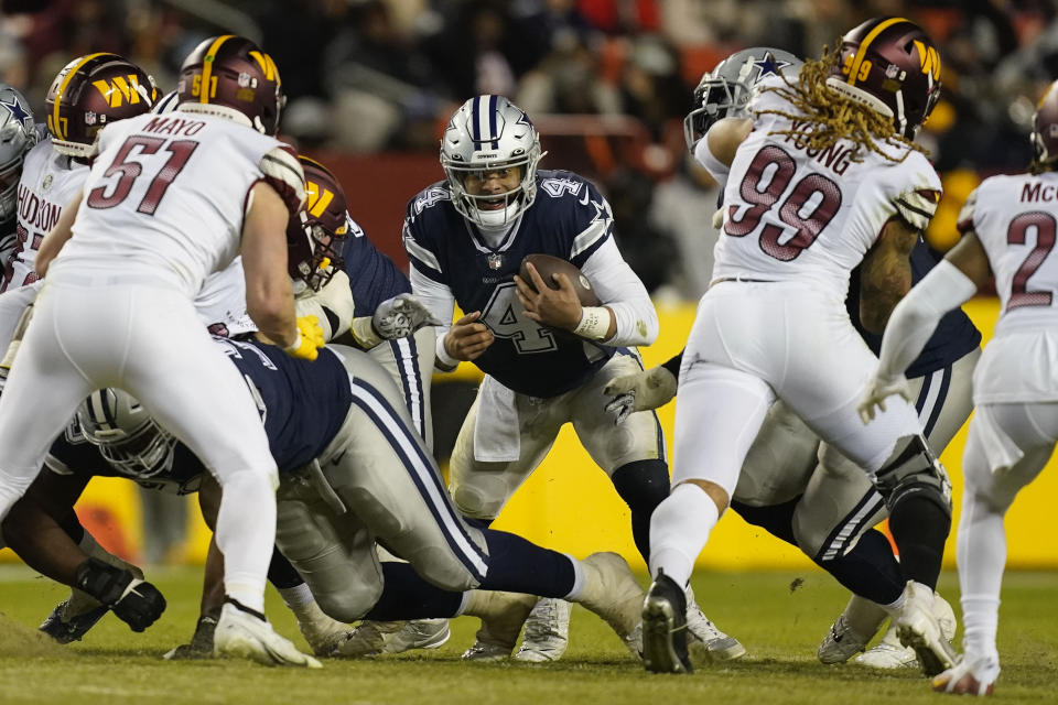 Dallas Cowboys quarterback Dak Prescott (4) looking for an opening against the Washington Commanders during the second half an NFL football game, Sunday, Jan. 8, 2023, in Landover, Md. (AP Photo/Patrick Semansky)