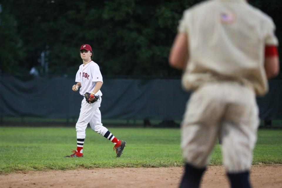 Joe Corsi, the son of the the late Red Sox pitcher Jim Corsi, takes to his position at left field during the 28th annual Abbot Financial Management Oldtime Baseball Game in Cambridge, Aug. 24, 2022.