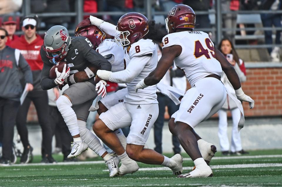 Nov 12, 2022; Pullman, Washington, USA; Washington State Cougars wide receiver Lincoln Victor (5) carries the ball against Arizona State Sun Devils linebacker Merlin Robertson (8) in the first half at Gesa Field at Martin Stadium.