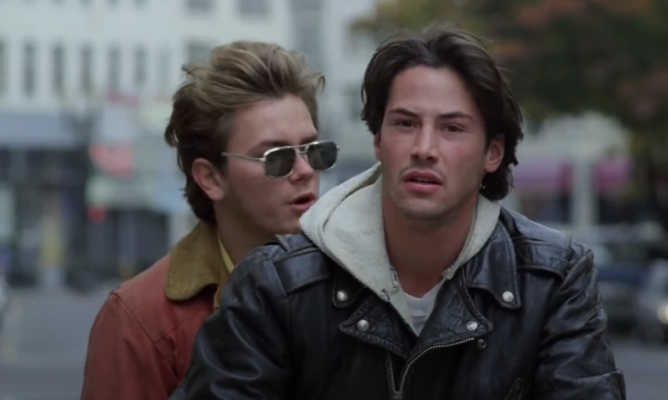 Cool, bohemian Reeve rides a motorcycle with an equally cool River Phoenix on the back in my own private idaho