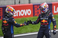 Winner Red Bull driver Max Verstappen of the Netherlands, right, congratulates third placed Red Bull driver Sergio Perez of Mexico at the end of the Chinese Formula One Grand Prix at the Shanghai International Circuit, Shanghai, China, Sunday, April 21, 2024. (AP Photo)