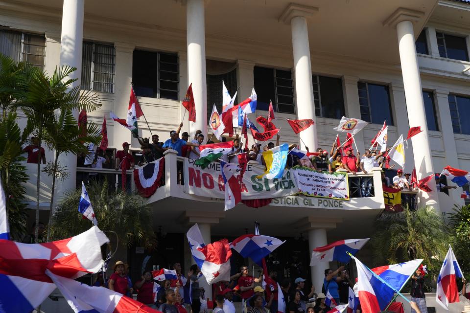 Protesters celebrate as they learn that Panama's Supreme Court has declared unconstitutional a 20-year concession for a Canadian copper mine that had sparked weeks of protests, in Panama City, Tuesday, Nov. 28, 2023. (AP Photo/Arnulfo Franco)