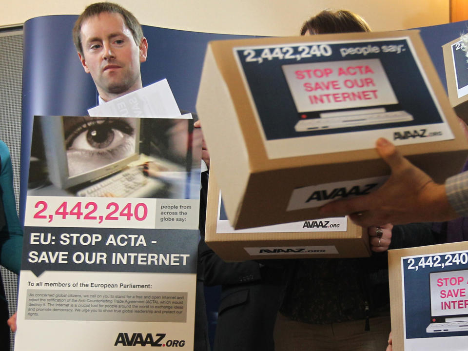 Avaaz's campaign director Alex Wilks talks to the media as he hands a petition against the Anti-Counterfeiting Trade Agreement (ACTA), to members of the European Parliament, at the European Parliament in Brussels, Tuesday, Feb. 28, 2012. Avaaz is an organization that uses the Internet to mobilize support for various political issues. (AP Photo/Yves Logghe)