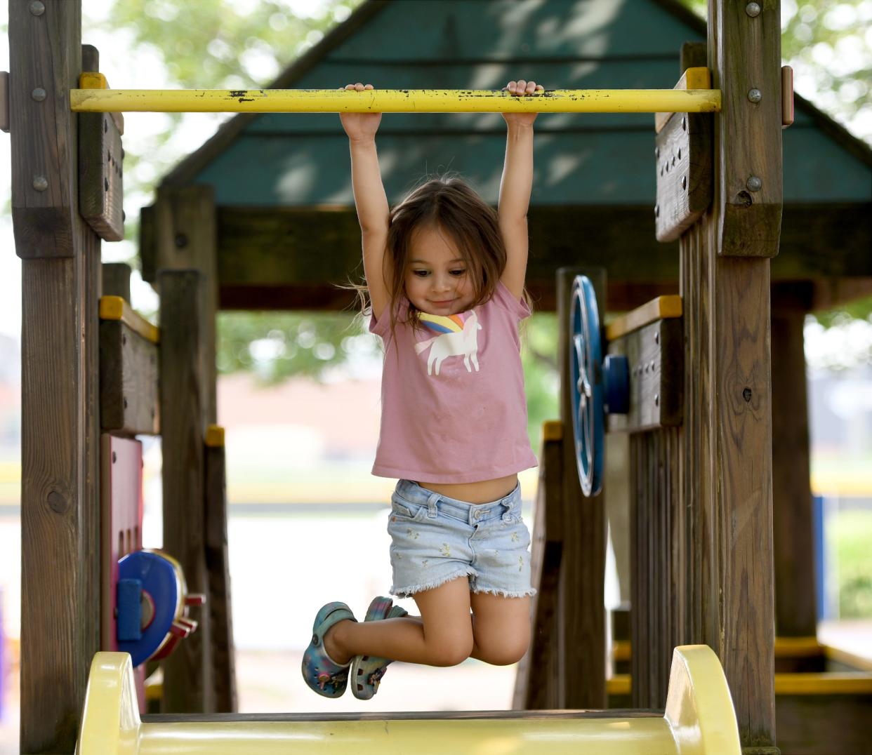 Valentina Carbajal, 3, of Massillon tries out her hanging skills at North Park in Jackson Township.