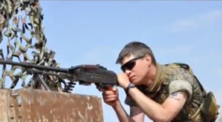 Levi Jonathan Shirley, an American volunteer with Kurdish forces, uses a light machine gun in an unknown location in this still image taken from video released July 22, 2016. Handout/YPG via Reuters TV