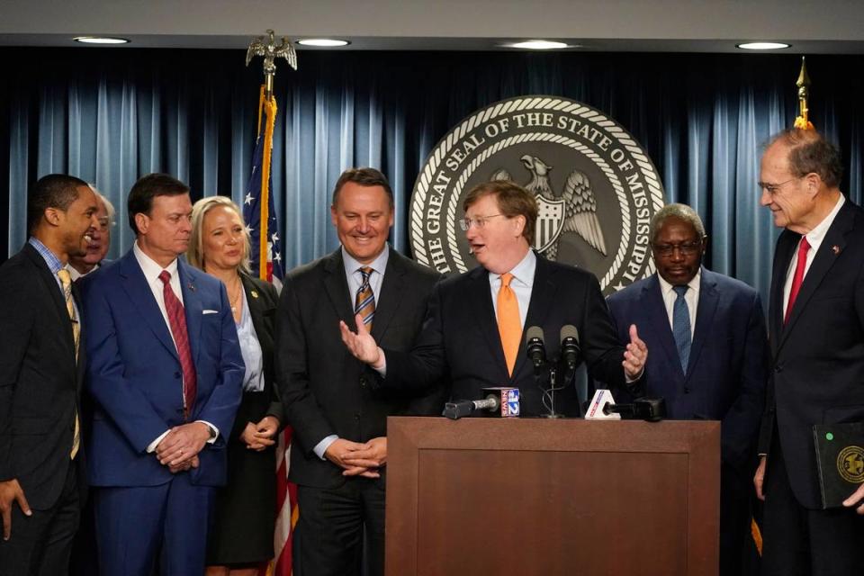 Mississippi Republican Gov. Tate Reeves, center, thanks legislators for their work on supporting efforts to bring a tech company to Mississippi.