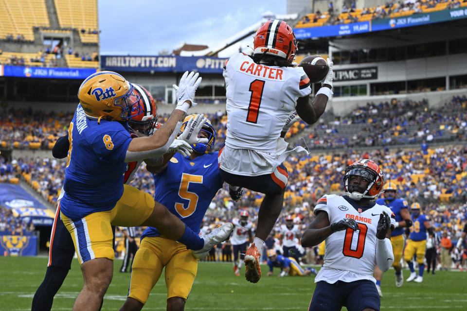 Syracuse defensive back Ja'Had Carter (1) intercepts a pass intended for Pittsburgh tight end Karter Johnson (8) during the first half of an NCAA college football game, Saturday, Nov. 5, 2022, in Pittsburgh. (AP Photo/Barry Reeger)