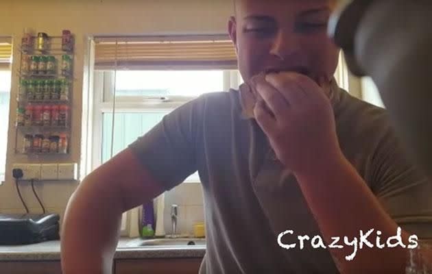 Daniel starts chowing down on the sandwich, only to quickly realise something is very wrong. Photo: Youtube