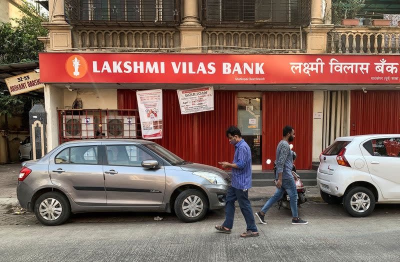 FILE PHOTO: People walk past a Lakshmi Vilas Bank branch in Mumbai