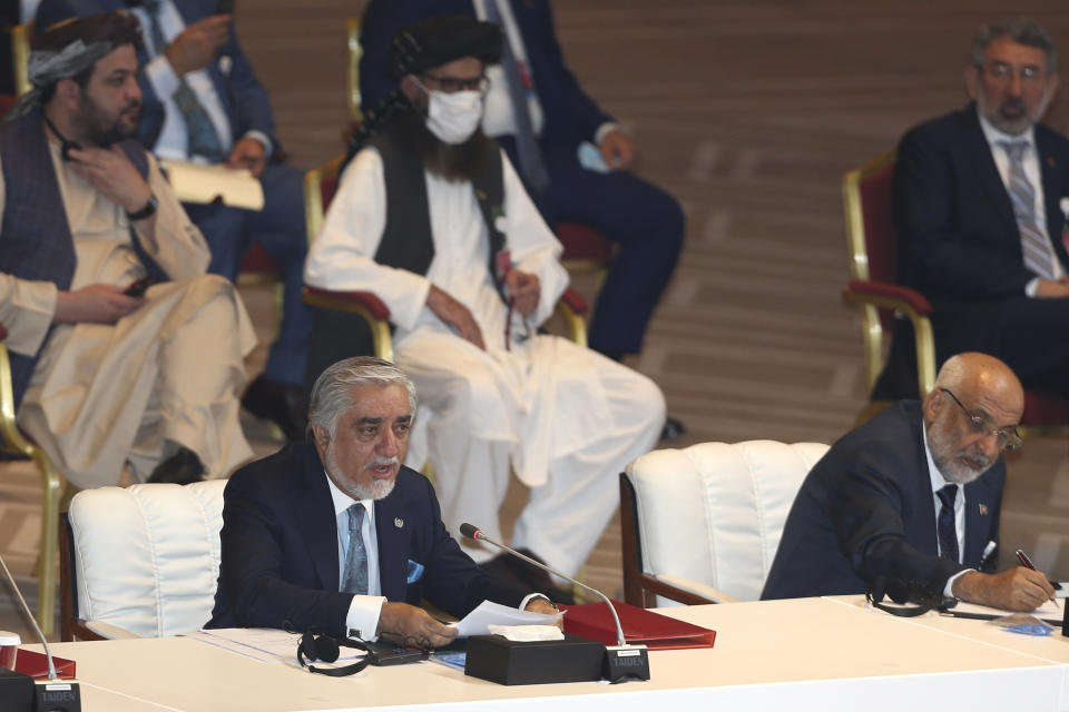 Abdullah Abdullah, left, chairman of Afghanistan's High Council for National Reconciliation, talks at the opening session of the peace talks between the Afghan government and the Taliban in Doha, Qatar, Saturday, Sept. 12, 2020. (AP Photo/ Hussein Sayed)