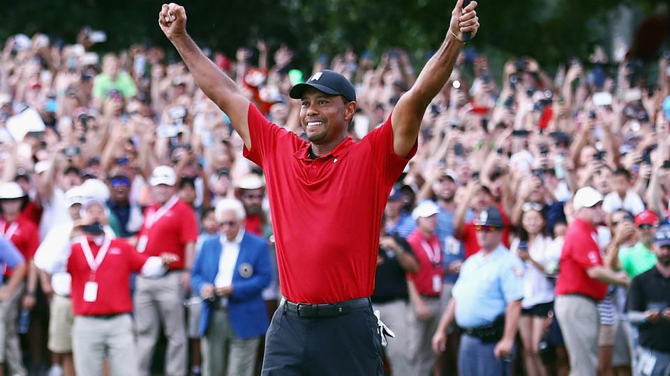 Tiger Woods celebrates. (Photo by Tim Bradbury/Getty Images)