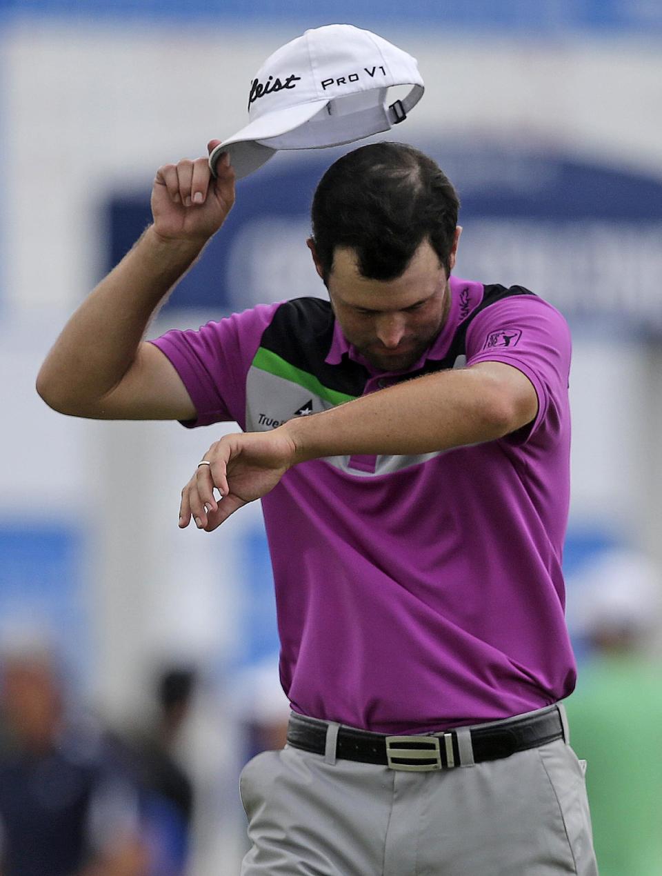 Robert Streb reacts after his double bogey on the ninth hole while tied for first place during the final round of the Zurich Classic golf tournament at TPC Louisiana in Avondale, La., Sunday, April 27, 2014. (AP Photo/Gerald Herbert)