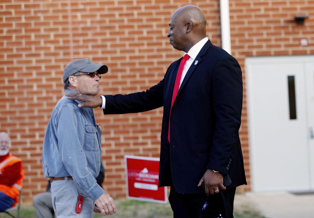 Candidate Leon Benjamin, right, greets Bobby Tucker as he heads into the Thomas Dale High School polling station in Richmond, Va., on Tuesday, Feb. 21, 2023. Benjamin is running to succeed Rep. Donald McEachin, D-4th. (Eva Russo/Richmond Times-Dispatch via AP)