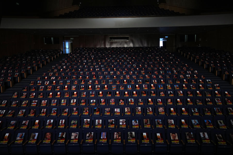 FILE - Photographs of over one thousand persons killed, missing or abducted in the Hamas attack on Israel on Oct. 7 are displayed on empty seats in an exhibit held under the motto "UNITED AGAINST TERRORISM" in the Smolarz Auditorium at Tel Aviv University on Oct. 22, 2023, in Tel Aviv. More than two weeks after Hamas' attack, many Israelis are furious at Prime Minister Benjamin Netanyahu's government, not just for failing to prevent the initial attack, but for failing to come to their aid afterward. While the military is bombing Gaza and preparing a possible invasion, Israeli government infighting and the erosion of the civil service have left traumatized survivors to mourn on their own. (AP Photo/Ohad Zwigenberg, File)