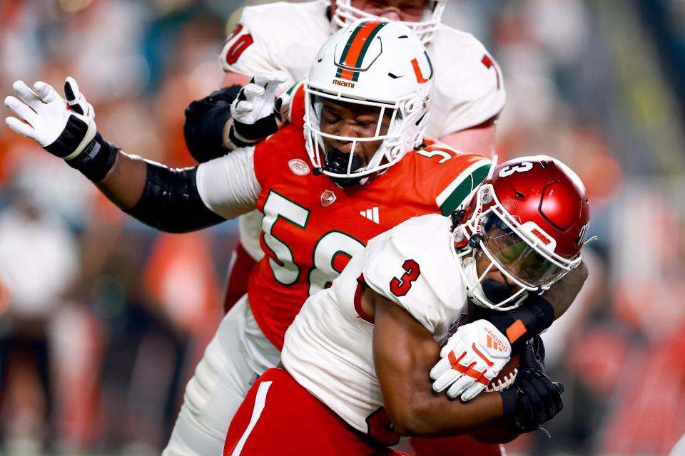 MIAMI GARDENS, FLORIDA - SEPTEMBER 01: Branson Deen #58 of the Miami Hurricanes tackles Keyon Mozee #3 of the Miami (Oh) Redhawks during the second quarter of the game at Hard Rock Stadium on September 01, 2023 in Miami Gardens, Florida. (Photo by Megan Briggs/Getty Images)