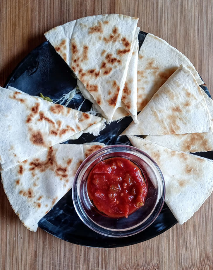 A cheese quesadilla with salsa
