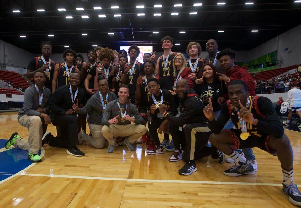 Florida High coaches and players pose following their state championship win over Riviera Prep, 67-66, on March 4, 2022, at R.P. Funding Center.