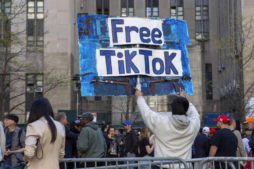 FILE - A man carries a Free TikTok sign in front of the courthouse where the hush-money trial of Donald Trump got underway April 15, 2024, in New York. The House has passed legislation Saturday, April 20, to ban TikTok in the U.S. if its China-based owner doesn't sell its stake, sending it to the Senate as part of a larger package of bills that would send aid to Ukraine and Israel. House Republicans' decision to add the TikTok bill to the foreign aid package fast-tracked the legislation after it had stalled in the Senate. The aid bill is a priority for President Joe Biden that has broad congressional support. (AP Photo/Ted Shaffrey, File)