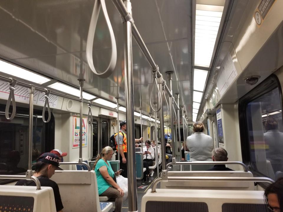 People sitting on a subway train.