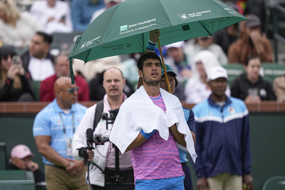 Carlos Alcaraz, of Spain, looks on during a rain delay in his semifinal match against Jannik Sinner, of Italy, at the BNP Paribas Open tennis tournament, Saturday, March 16, 2024, in Indian Wells, Calif. (AP Photo/Mark J. Terrill)