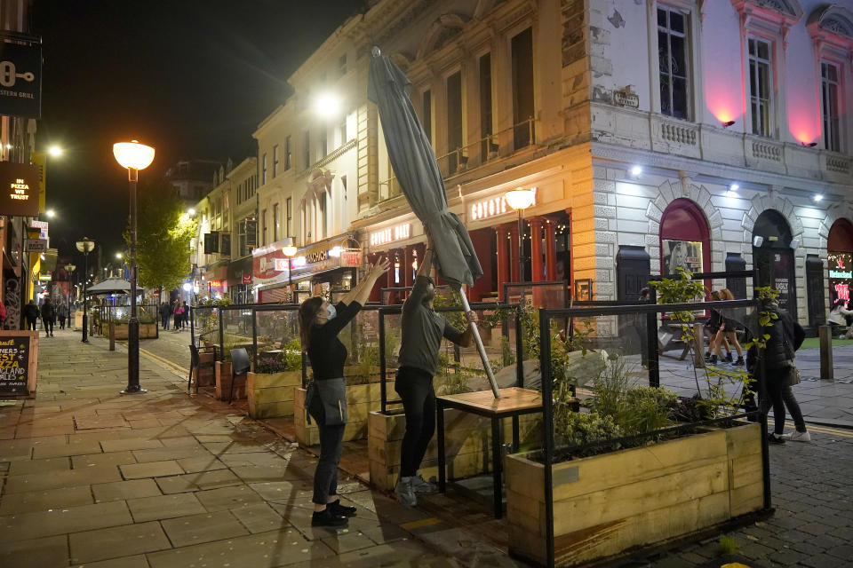 LIVERPOOL, ENGLAND - OCTOBER 13: Restaurant staff clear away their street furniture in the city centre on the eve of lockdown restrictions on October 13, 2020 in Liverpool, England. As the British government announced a new three-tier system for ranking the severity of local COVID-19 spread, the Liverpool City Region was immediately ranked "very high" risk, forcing its pubs, bars, gyms and leisure centres to close from Wednesday. (Photo by Christopher Furlong/Getty Images)