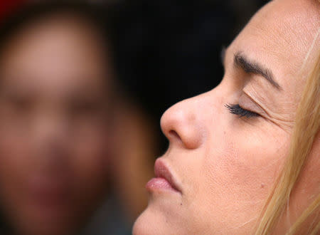 Lilian Tintori, wife of jailed Venezuelan opposition leader Leopoldo Lopez, closes her eyes as she sits on the pavement near St. Peter's Square in Rome, Italy December 6, 2016. REUTERS/Stefano Rellandini