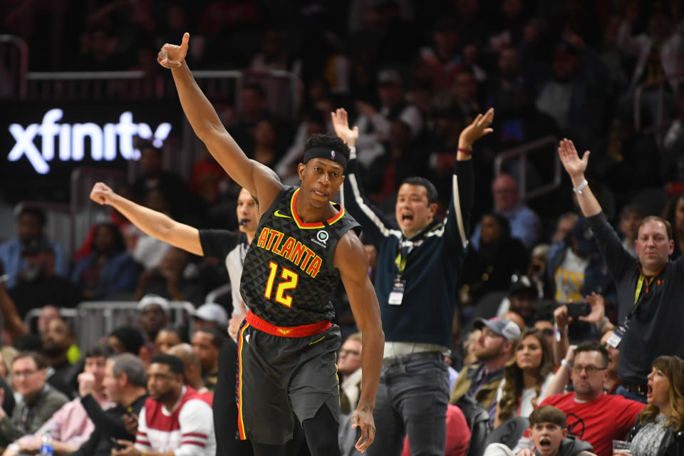 Atlanta Hawks forward De'Andre Hunter (12) reacts after scoring against the Portland Trail Blazers during the second half of an NBA basketball game Saturday, Feb. 29, 2020, in Atlanta. (AP Photo/John Amis)