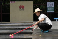 A worker washes the steps outside an entrance to the sprawling Huawei headquarters campus in Shenzhen, China, Saturday, Sept. 25, 2021. Two Canadians detained in China on spying charges were released from prison and flown out of the country on Friday, Prime Minister Justin Trudeau said, just after a top executive of Chinese communications giant Huawei Technologies reached a deal with the U.S. Justice Department over fraud charges and flew to China. (AP Photo/Ng Han Guan)