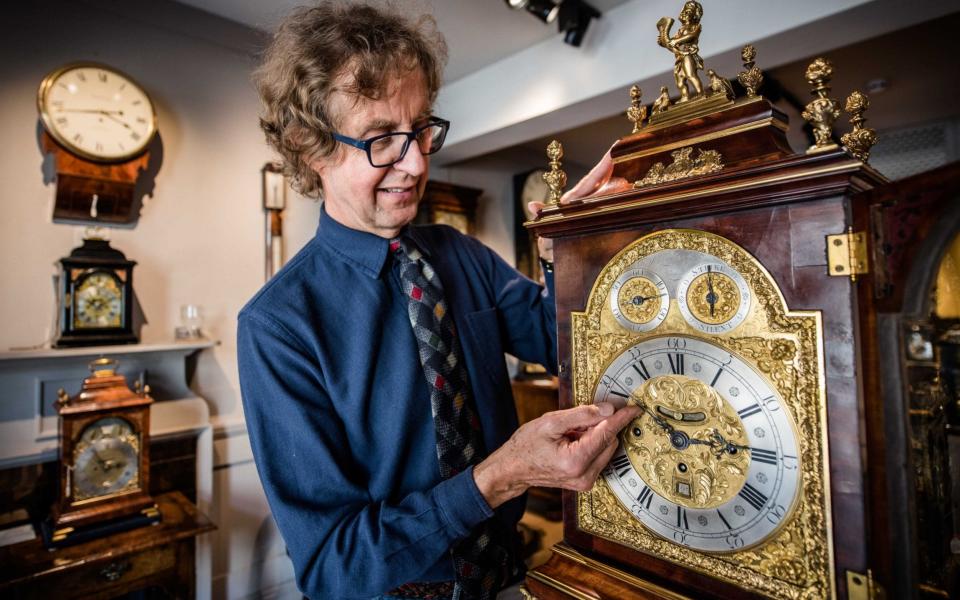 Antique clock seller Howard Walwyn goes through his shop in Kensington, London, changing the time on all the clocks - John Nguyen/JNVisuals